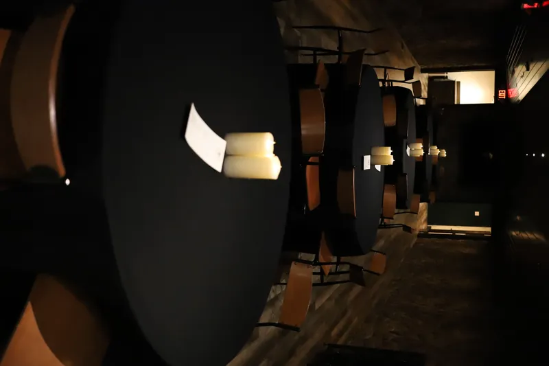 Round table with black linens and candles at Bella Vino