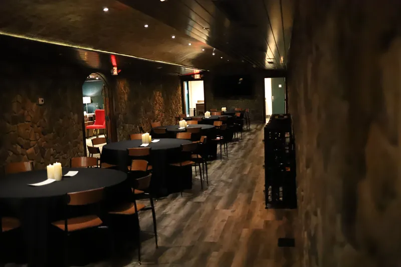 Bella Vino wine cellar event room with tables and stone walls