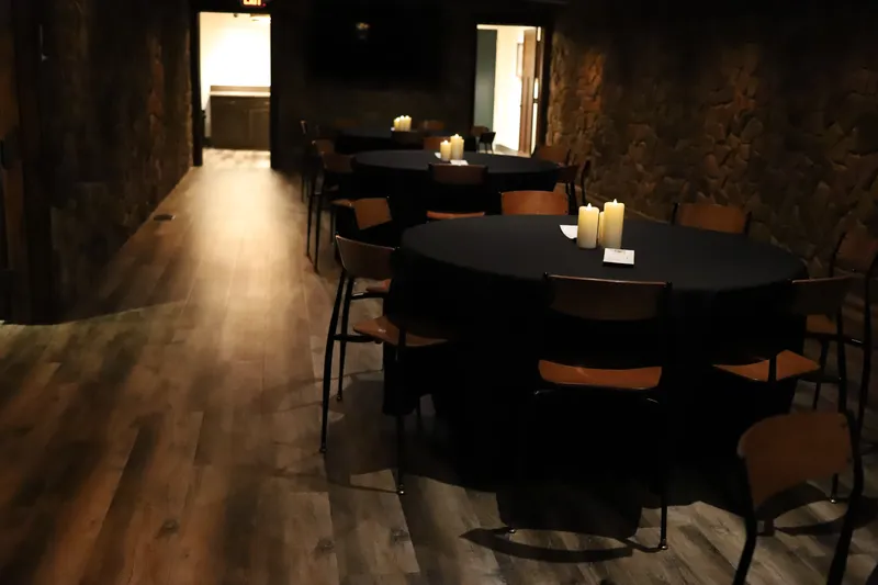 Bella Vino wine cellar event room with round tables and stone walls in Bellefontaine OH