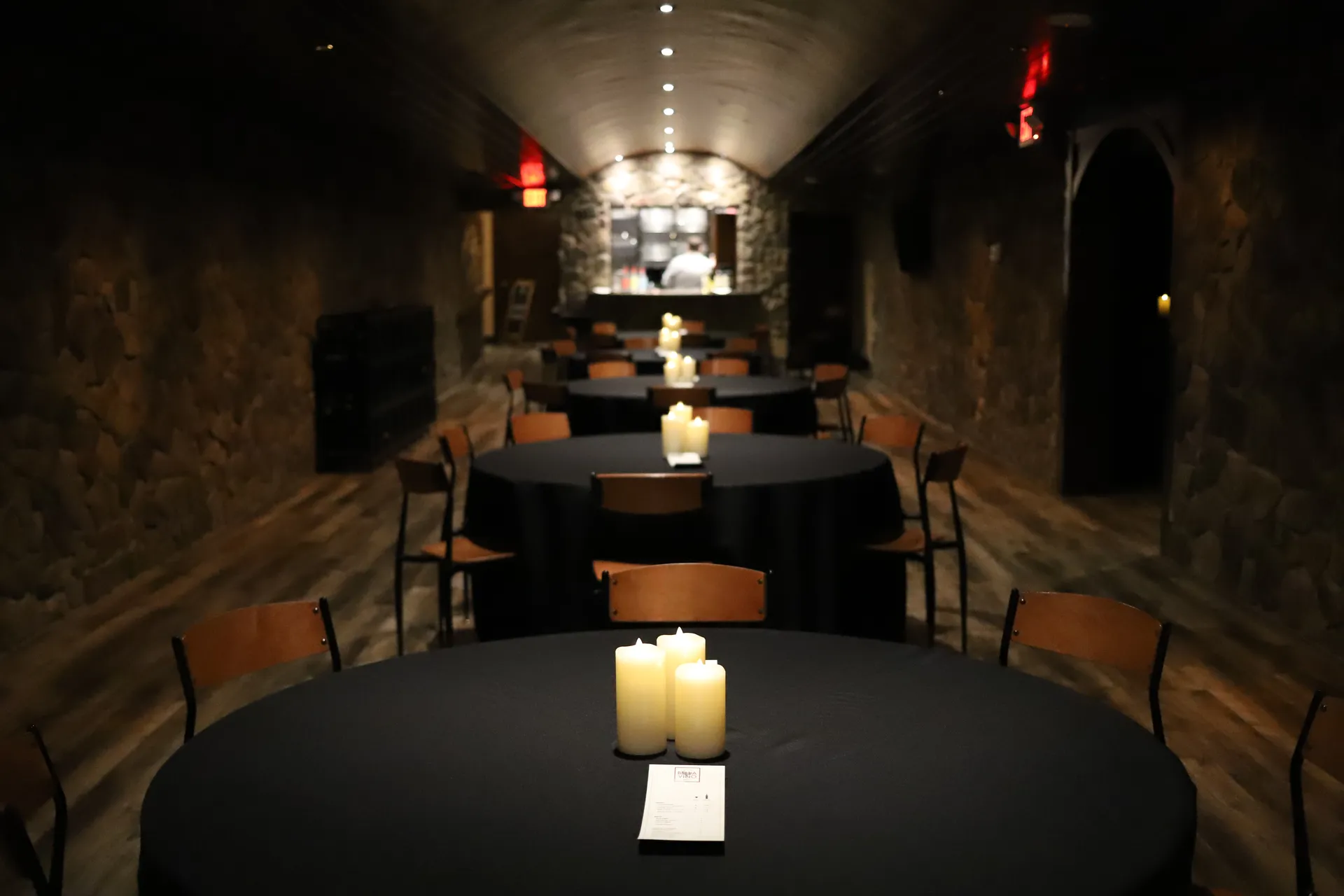 Bella Vino event room with stone walls and candlelit tables in Bellefontaine, Ohio