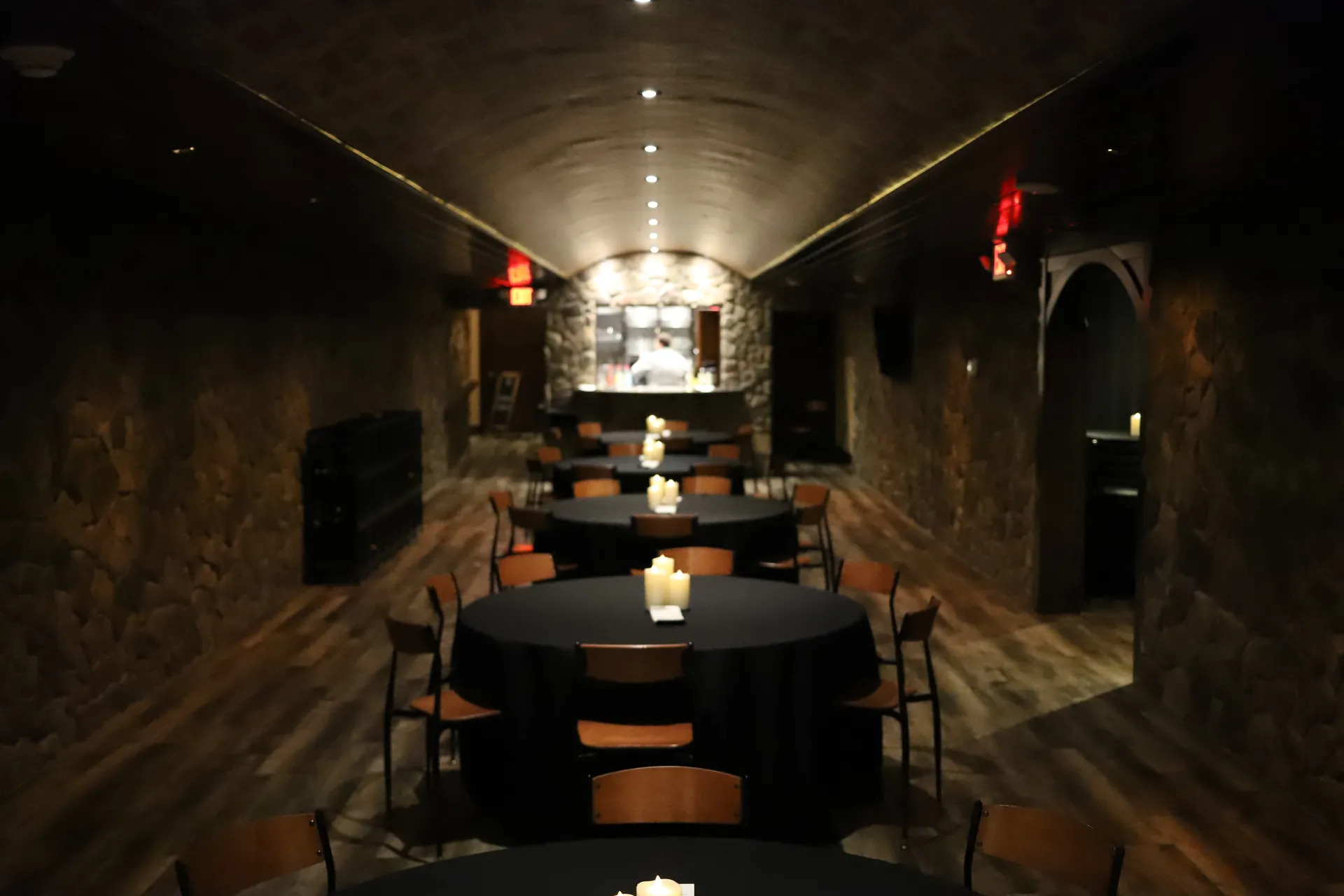 Bella Vino wine cellar event room with stone walls, brick ceiling, and elegant table settings in Bellefontaine OH