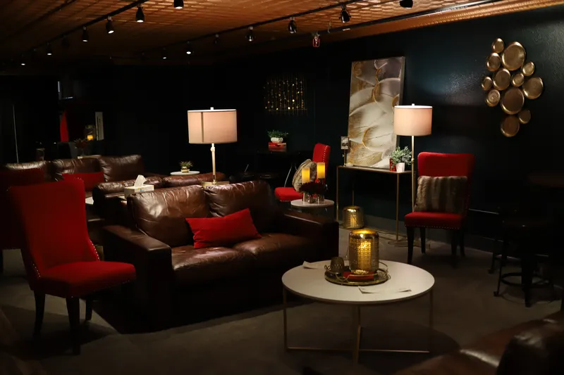 Bella Vino lounge with leather sofas and red velvet chairs