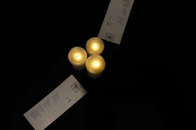 Candlelit table setting with Bella Vino menu at event venue